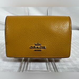 2089: Coach Mustard Yellow Pebbled Leather Trifold Wallet
